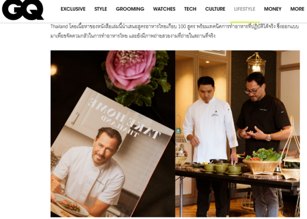 Two chefs prepare a meal in a high-end kitchen with a magazine cover nearby.