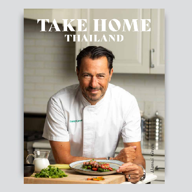 Chef presenting a gourmet dish in a modern kitchen.